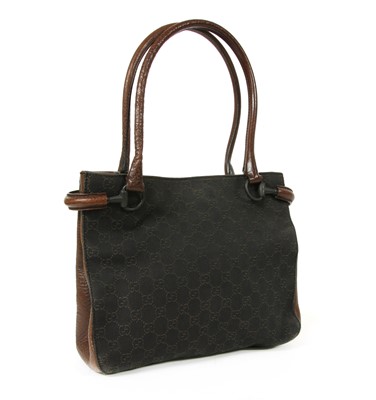 Lot 32 - A Gucci dark brown canvas curved handle bag