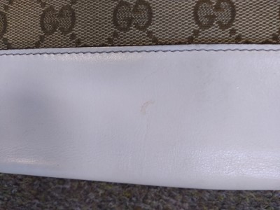 Lot 101 - A Gucci beige monogrammed canvas and cream leather heart bi-fold wallet