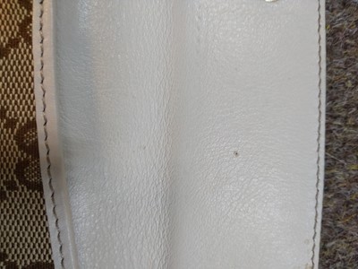 Lot 101 - A Gucci beige monogrammed canvas and cream leather heart bi-fold wallet