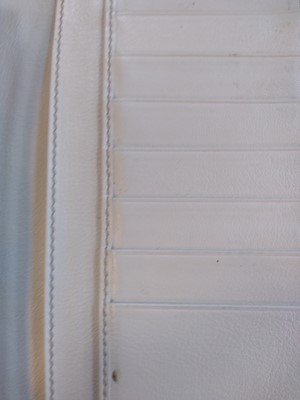 Lot 101 - A Gucci beige monogrammed canvas and cream leather heart bi-fold wallet