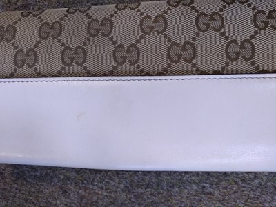 Lot 101 - A Gucci beige monogrammed canvas and cream leather heart bi-fold wallet