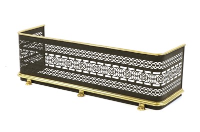 Lot 771 - A brass and ebonised fender