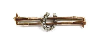 Lot 15 - A gold and silver diamond set horseshoe bar brooch