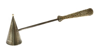 Lot 407 - A silver gilt candle snuffer