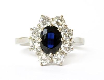 Lot 106 - A platinum sapphire and diamond cluster ring