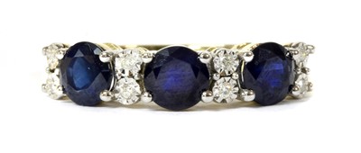 Lot 147 - A gold eleven stone sapphire and diamond ring