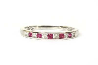 Lot 121 - A 9ct white gold ruby and diamond half eternity ring