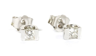 Lot 103 - A pair of white gold single stone diamond stud earrings