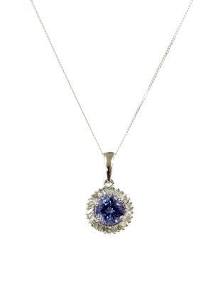Lot 166 - A white gold tanzanite and diamond cluster pendant