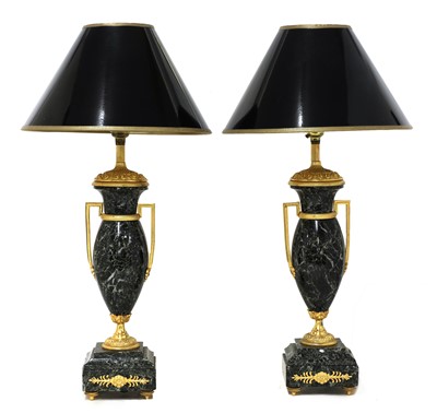 Lot 216 - A pair of French serpentine marble urn-form table lamps