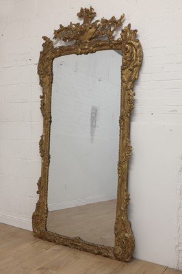 Lot 266 - A large carved giltwood wall mirror
