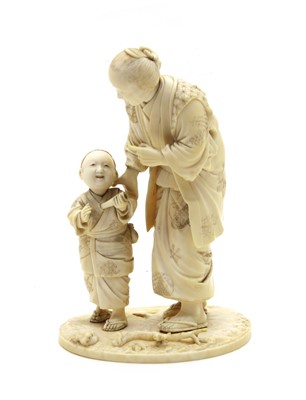 Lot 193 - A Japanese sectional carved ivory figure of a mother and child
