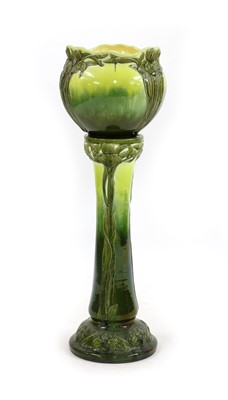 Lot 103 - A Burmantofts Faience Pottery green glazed jardinière on stand