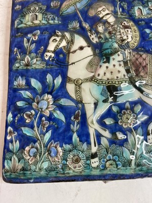 Lot 947 - A near pair of Qajar pottery tiles