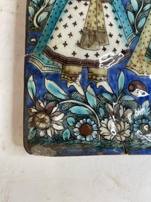 Lot 947 - A near pair of Qajar pottery tiles