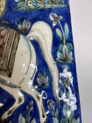 Lot 947 - A near pair of Qajar pottery tiles