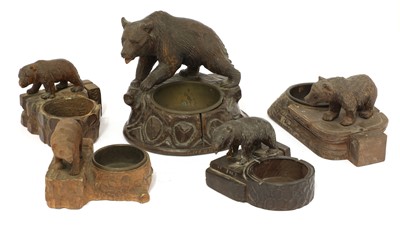 Lot 369 - Five carved wooden Black Forest menu holders