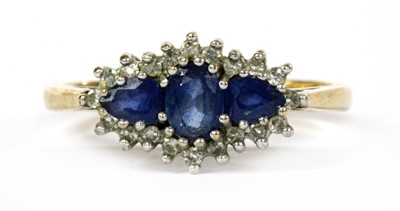 Lot 109 - A 9ct gold sapphire and diamond three stone cluster ring