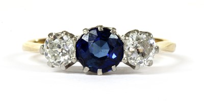 Lot 30 - A gold three stone sapphire and diamond ring