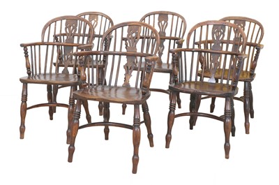Lot 701 - A matched set of six yew and elm low hoop back Windsor armchairs