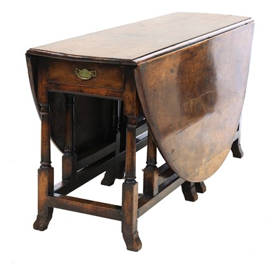 Lot 700 - A yew double gateleg drop-leaf table