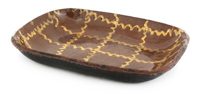 Lot 702 - A Staffordshire pottery slipware baking dish