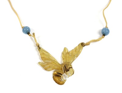 Lot 10 - An Art Nouveau carved horn pendant