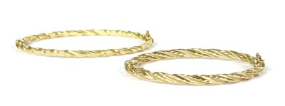 Lot 197 - A 14ct gold oval hollow twisted wire bangle