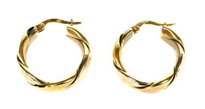 Lot 74 - A pair of 9ct white and yellow gold twisted wire hoop earrings