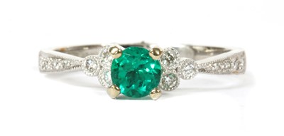 Lot 109 - An 18ct white gold emerald and diamond ring