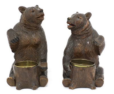Lot 63 - A near opposing pair of carved Black Forest bear ashtrays