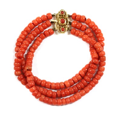 Lot 24 - A three row uniform coral bead bracelet