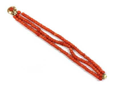 Lot 23 - A three row uniform coral bead bracelet