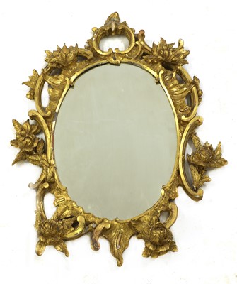 Lot 218 - A carved giltwood rococo-style oval mirror