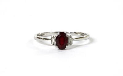 Lot 115 - A white gold three stone ruby and diamond ring