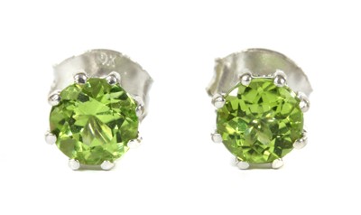 Lot 172 - A pair of white gold single stone peridot stud earrings