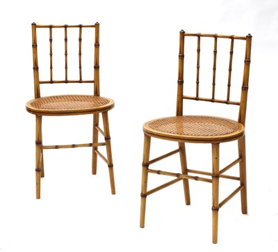 Lot 214 - A pair of Regency-style faux bamboo side chairs