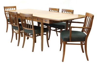 Lot 394 - A Gordon Russell fiddleback mahogany dining table
