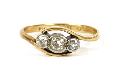 Lot 47 - A gold three stone diamond crossover ring