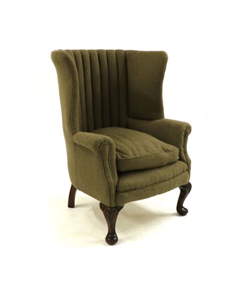 Lot 299 - A Georgian style barrel back wing armchair