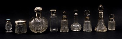 Lot 33 - A collection of cut glass silver topped scent bottles