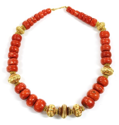 Lot 235 - A single row graduated coral and high carat gold bead necklace