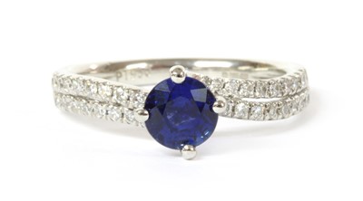 Lot 126 - A platinum single stone sapphire crossover ring