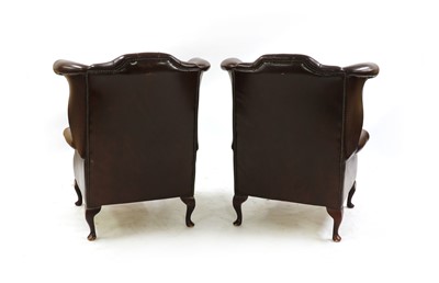 Lot 297 - A pair of Queen Anne-style wingback armchairs