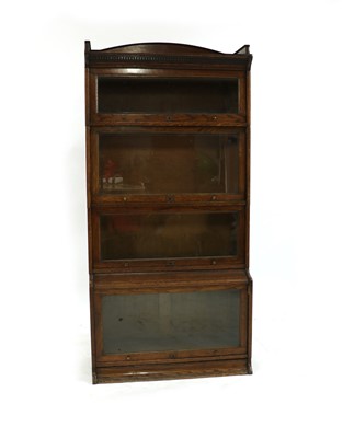Lot 252 - An oak Lebos four-section bookcase