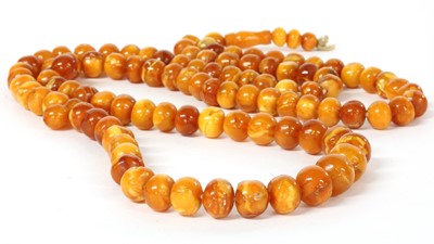 Lot 27 - A single row slightly graduated butterscotch amber prayer bead necklace