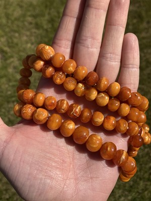 Lot 27 - A single row slightly graduated butterscotch amber prayer bead necklace