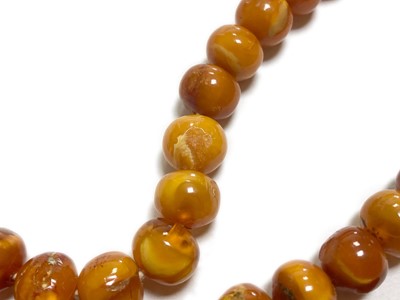 Lot 27 - A single row slightly graduated butterscotch amber prayer bead necklace