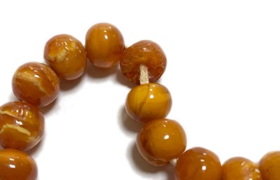 Lot 27 - A single row slightly graduated butterscotch amber prayer bead necklace