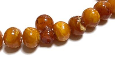 Lot 27 - A single row slightly graduated butterscotch amber prayer bead necklace